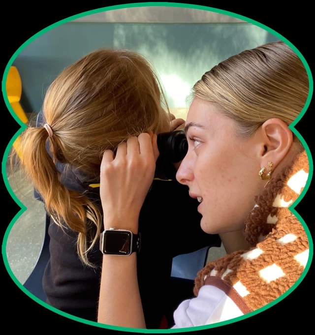 Two young women looking closely at a health check screen